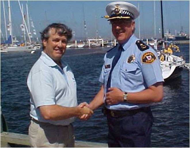 Past CYCA Commodore and SOLAS board member Martin James presents a cheque to Jack Johnson, the Assistant Police Commissioner representing Tasmanian Air Rescue © CYCA . http://www.cyca.com.au